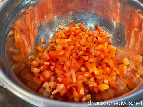 Diced tomatoes in a silver bowl.