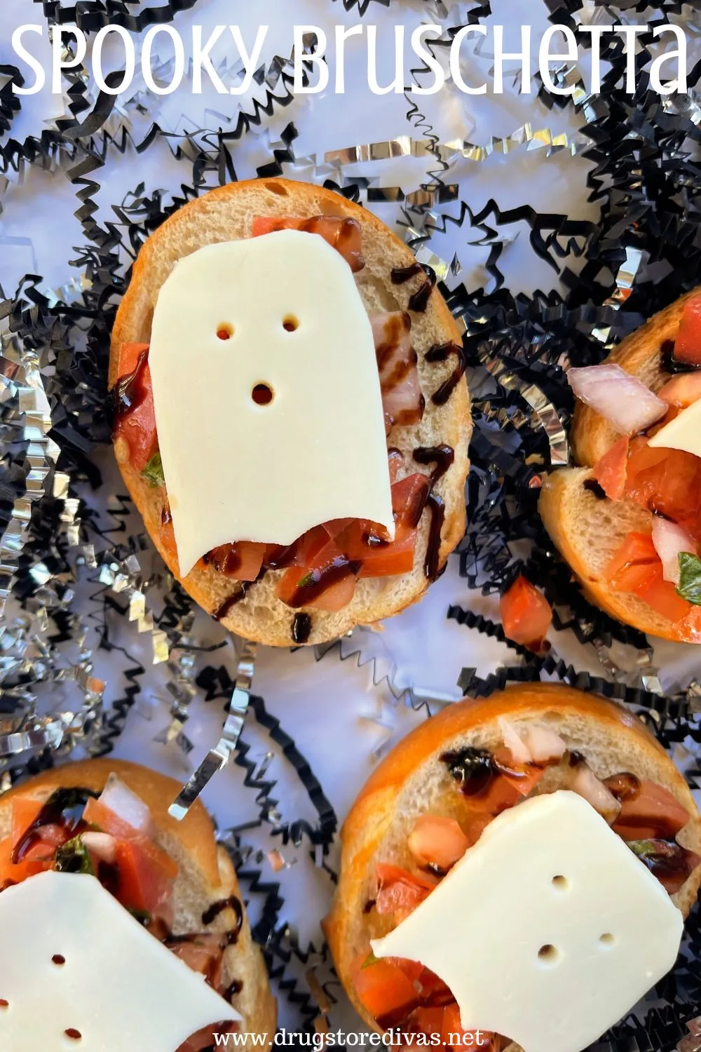 Cheese ghosts on top of toast with tomatoes with black and silver paper shred around them and the words 