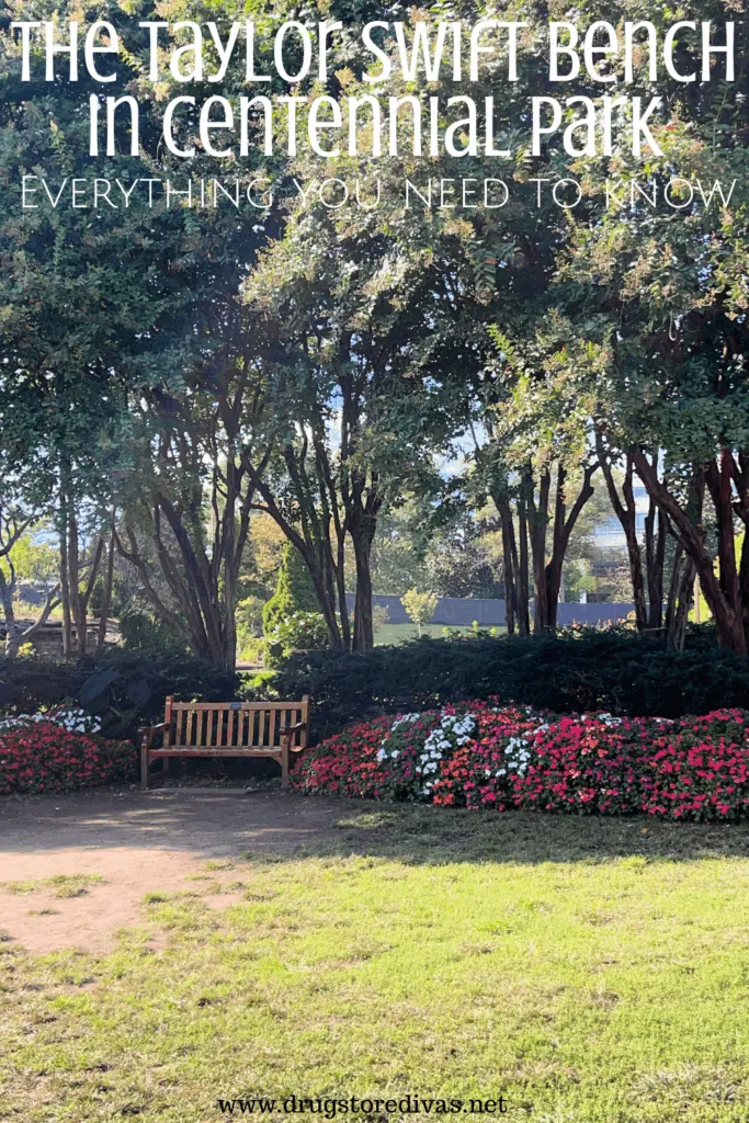 A bench under trees surrounded by flowers in a garden with the words "The Taylor Swift Bench in Centennial Park everything you need to know" digitally written above it.