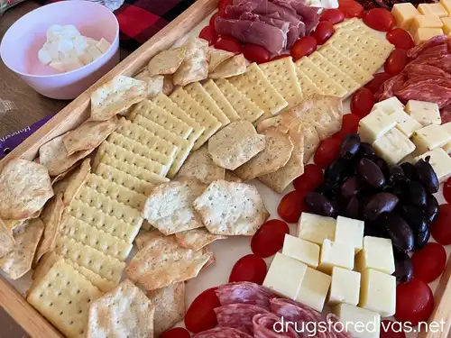 Crackers, cheese, and meat on a charcuterie board.