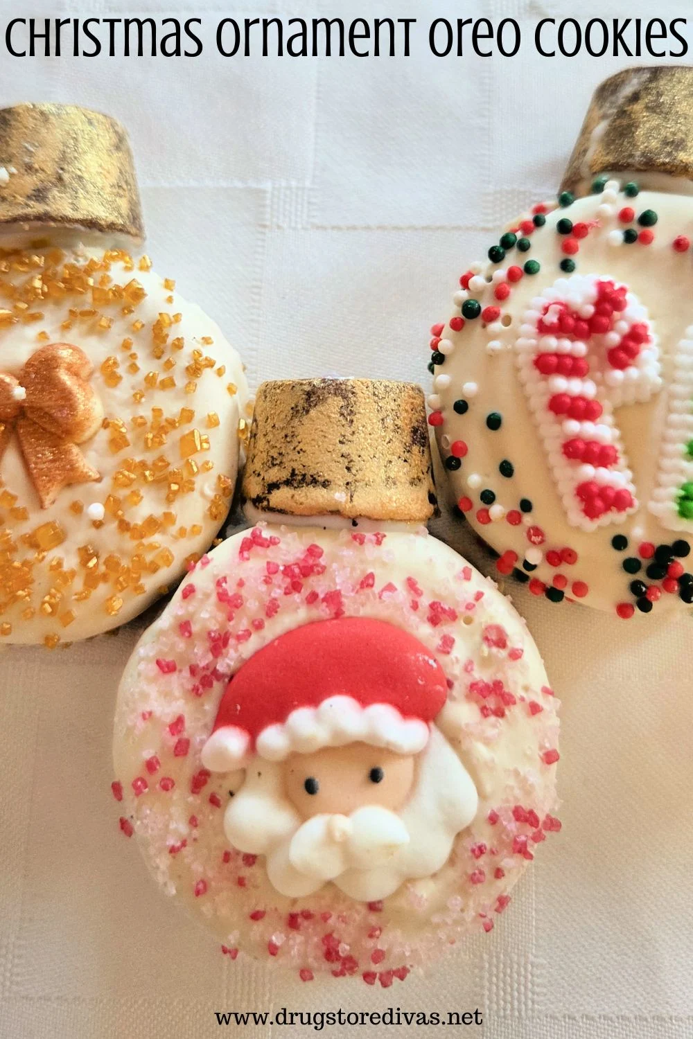 Three Oreo cookies decorated to look like Christmas ornaments -- one with a bow, one with Santa, and one with a candy cane -- with the words 