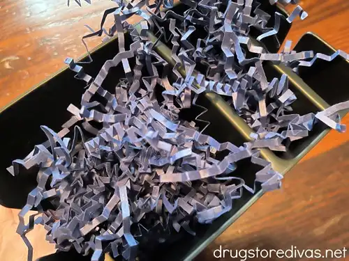 Blue paper shred in a car cup organizer.