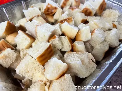 Cubes of bread in an aluminum tray.