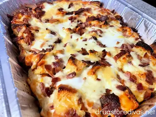 Baked Hawaiian Roll Breakfast Casserole in an aluminum tray.