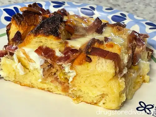 A slice of Hawaiian Bread Breakfast casserole on a plate with a blue and white edge.