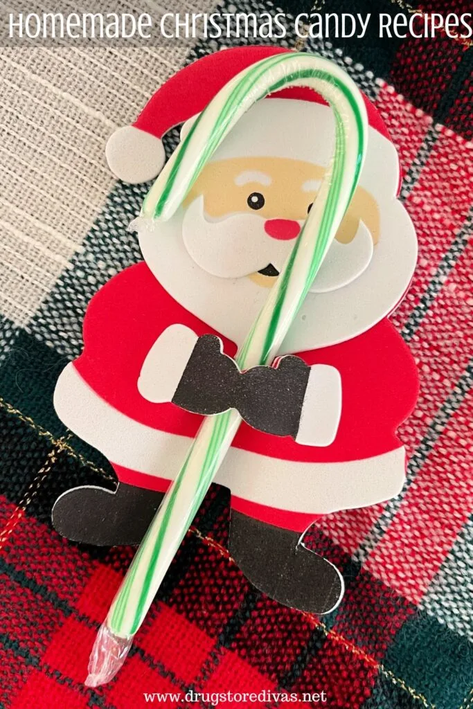 A foam Santa Claus holding a green and white candy cane with the words "Homemade Christmas Candy Recipes" digitally written above him.