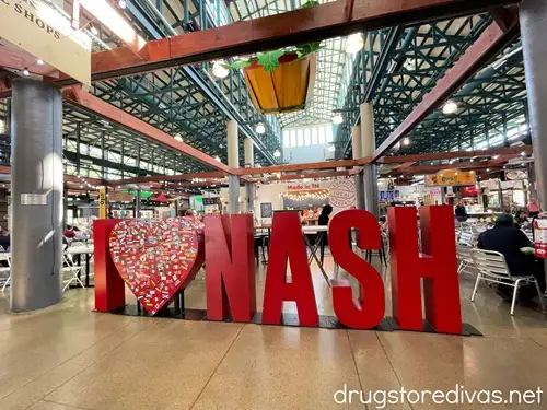 A large sign that says "I (heart) NASH" in the food court at the Nashville Farmers Market.