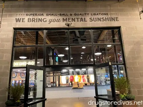 The entranceway to Pins Mechanical Co in Nashville with a painted wall that says "We Bring You Mental Sunshine". 