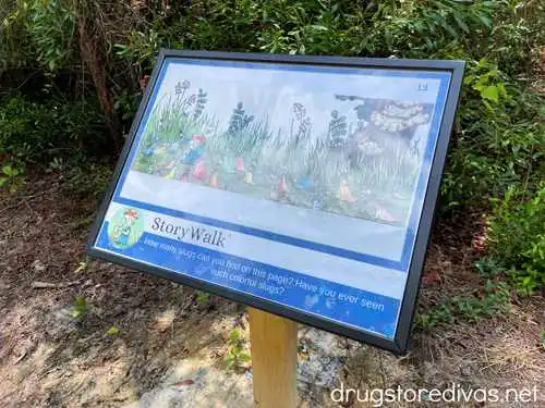 A story walk board in a park.