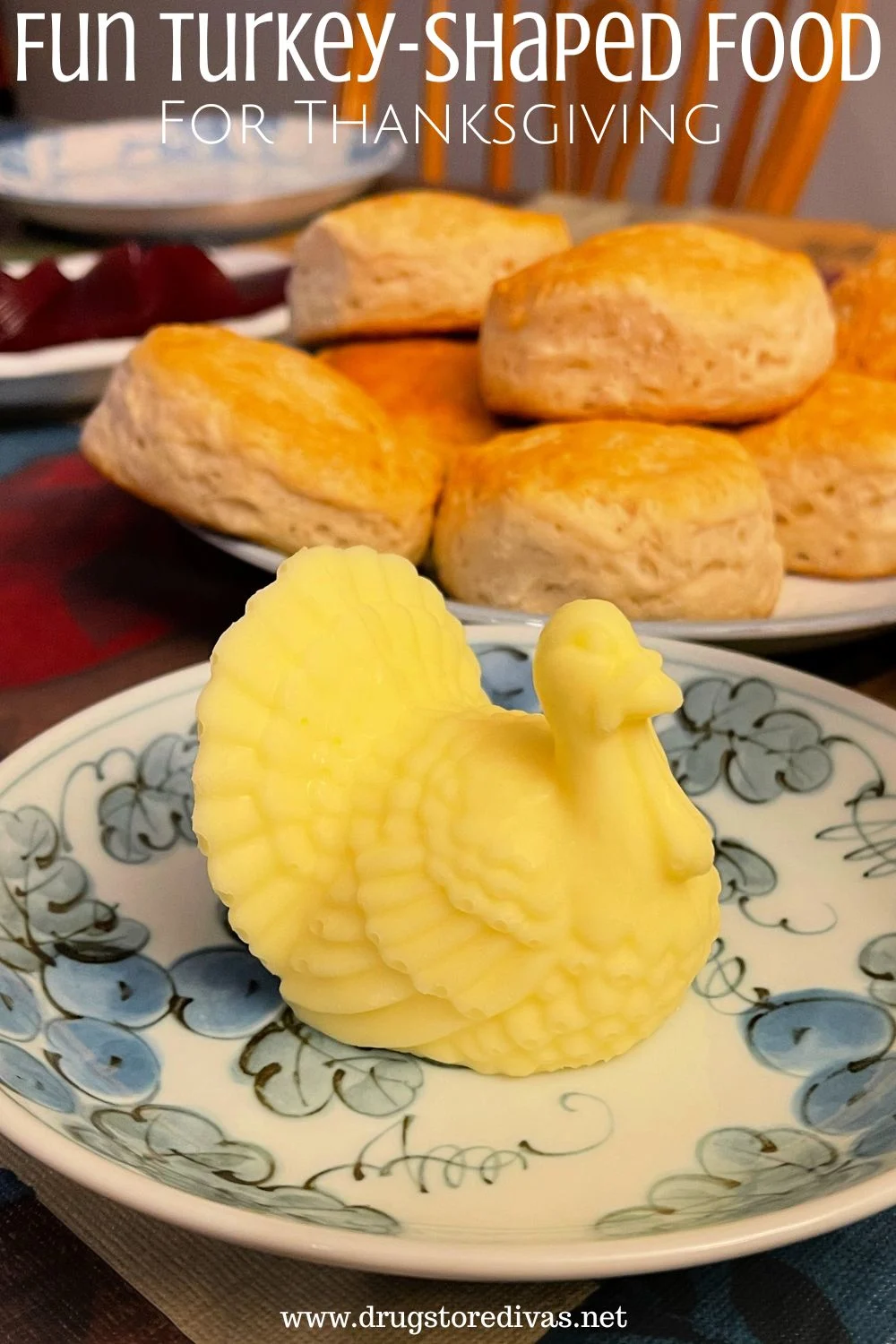 A turkey-shaped butter on a plate with rolls on a plate and cranberry sauce on another plate with the words 