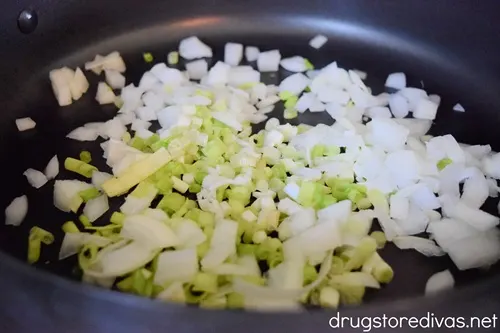 Chopped green and white onions in a pan.