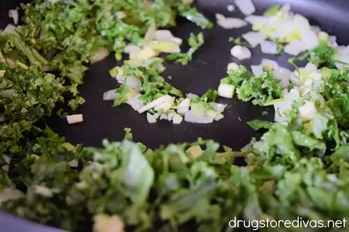 Garlic and kale in a pan.