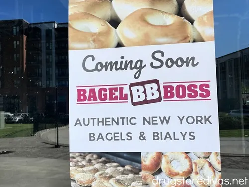 A sign advertising a Bagel Boss shop coming soon.