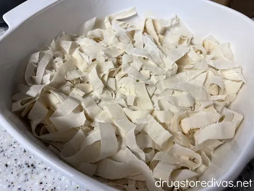 Strips of phyllo dough in a white pan.