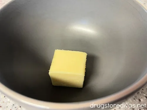 A cube of butter in a gray bowl.
