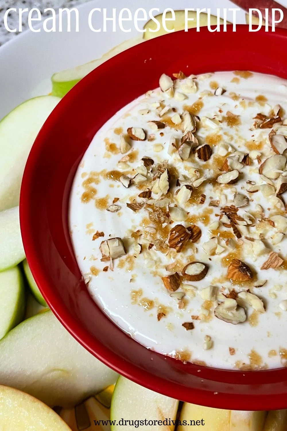 A white dip with brown sugar and nuts on top in a red bowl next to slices green apples and the words 