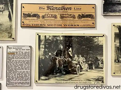 Newspaper clippings and photos about Marathon cars hung on a wall at Marathon Village in Nashville.