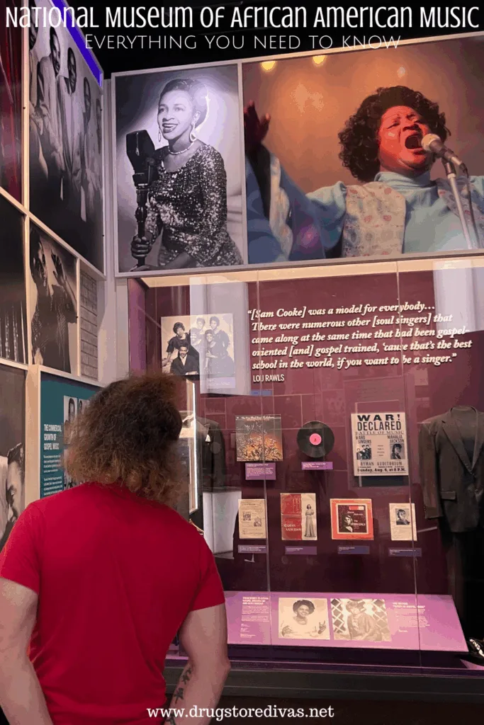 A man in a red shirt looking at an exhibit in a music museum with the words "National Museum Of African American Music: Everything you need to know" digitally written above him.