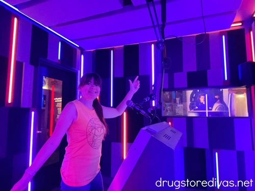 A woman in a yellow tank top in a rap studio in the National Museum Of African American Music in Nashville.