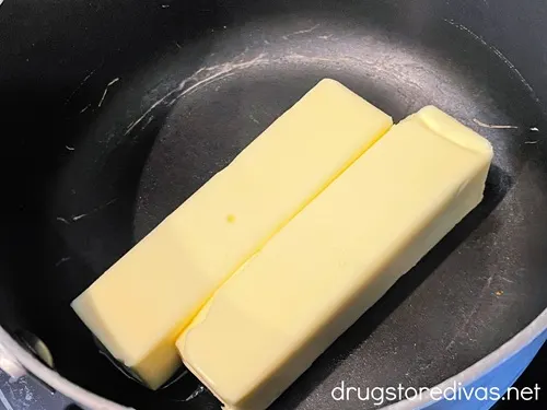 Two sticks of butter in a stockpot.