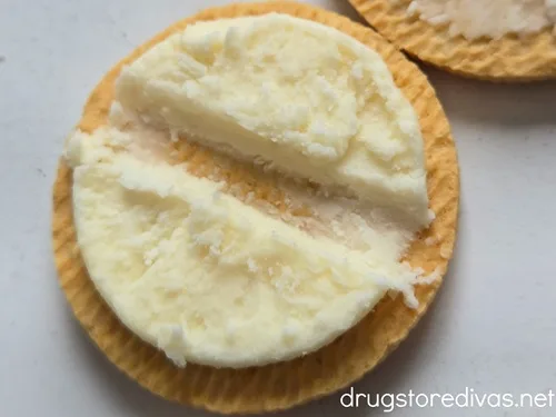 A Golden Oreo cookie with a divot in the cream.