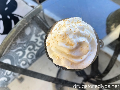 Finishing sugar on top of whipped cream on a glass.