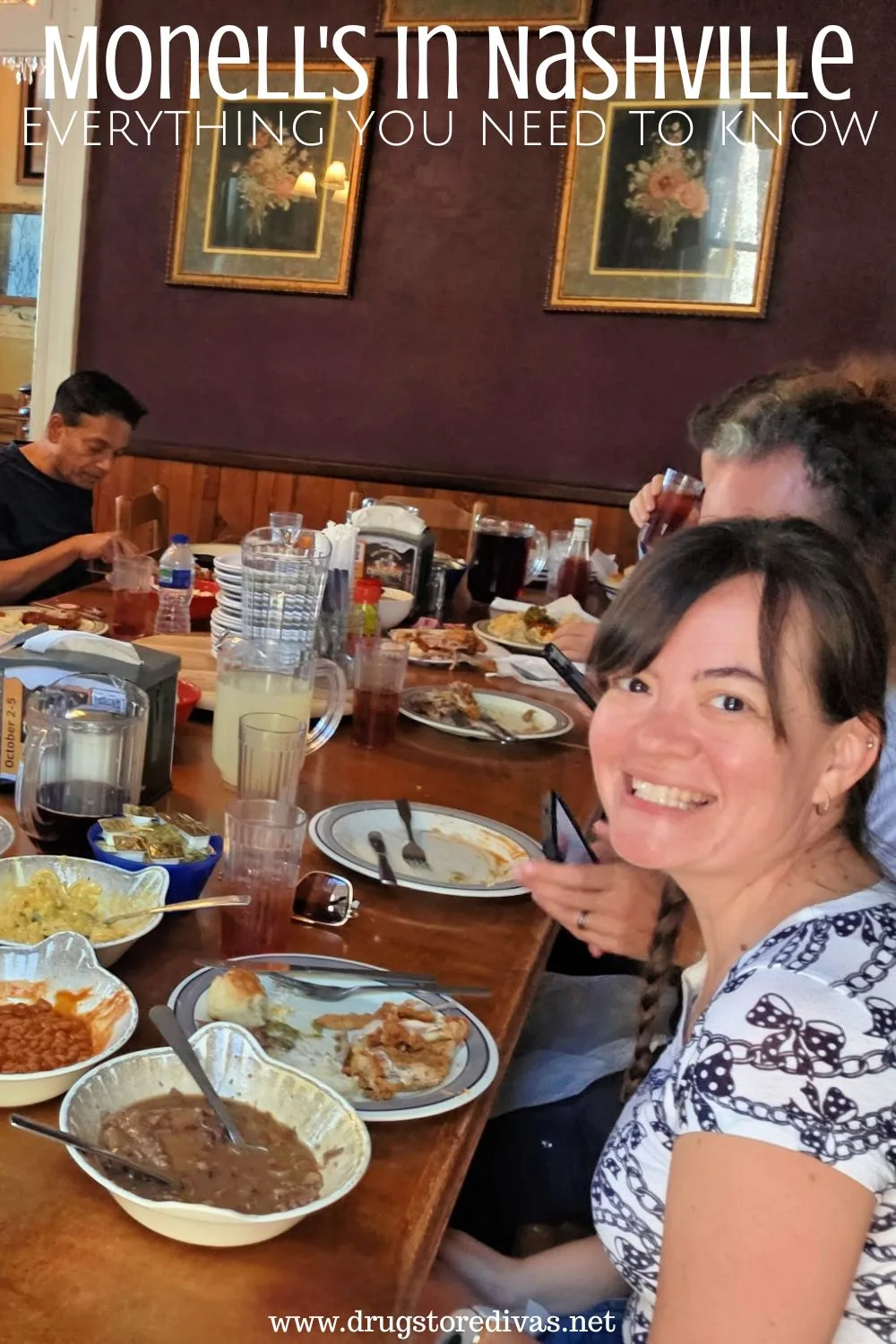 A woman looking at the camera with some other people at a table filled with food and the words 