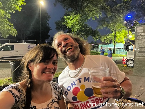 A man and a woman at night at Nashville Oktoberfest.