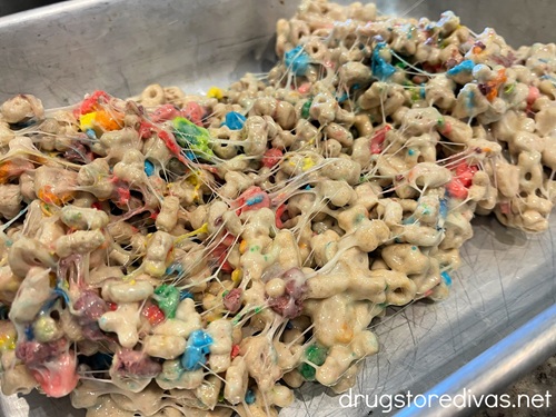 A mixture of Lucky Charms cereal and melted marshmallows in a silver baking tray.