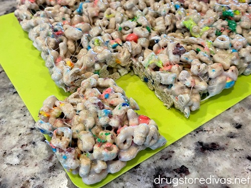 A batch of Lucky Charms marshmallow treats with just one cut out.