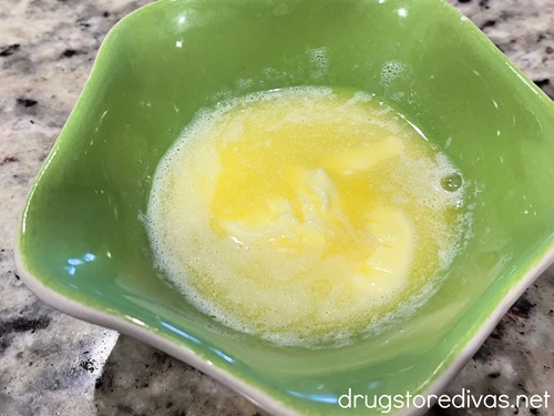 Melted butter in a green bowl.
