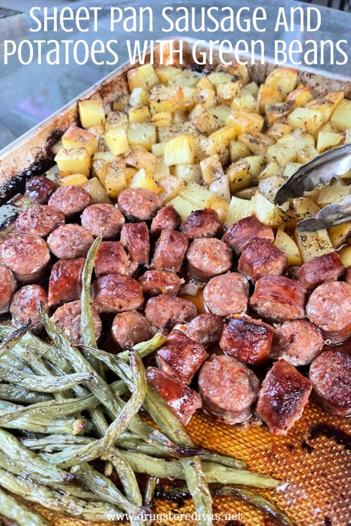 A sheet pan with cooked green beans, sausage rounds, and cubed potatoes on it with the words "Sheet Pan Sausage And Potatoes With Green Beans" digitally written on top.