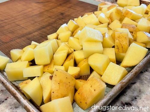 Diced yellow potatoes on a sheet pan.