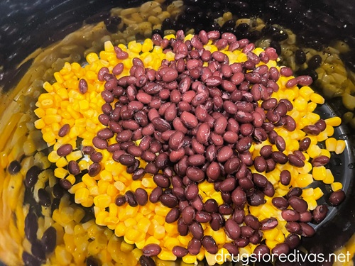 Corn kernels and black beans in a slow cooker.