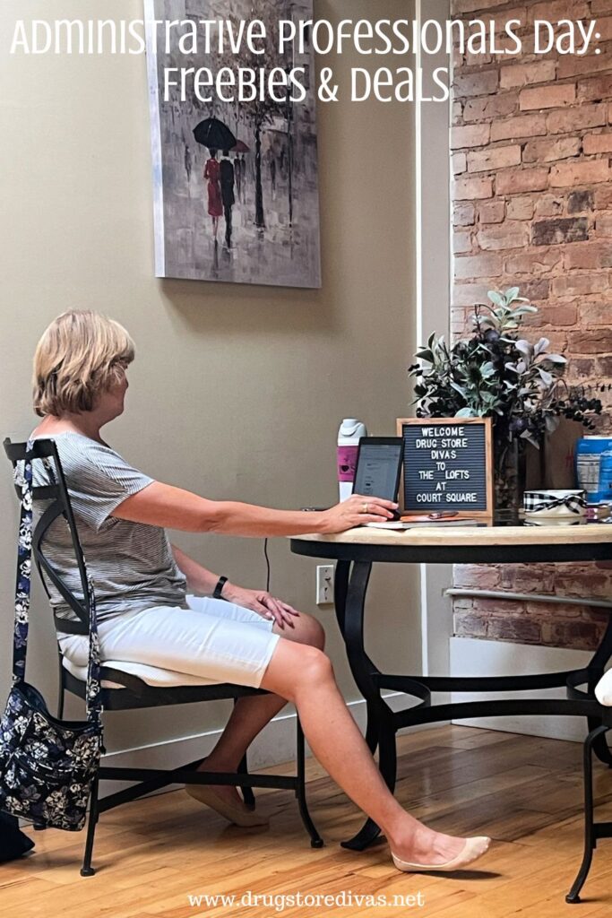 A woman sitting at a table and working on a laptop with the words "Administrative Professionals Day: Freebies & Deals" digitally written above her.