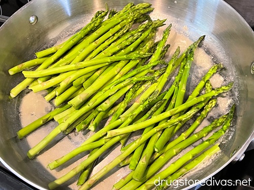 Asparagus in a silver skillet.