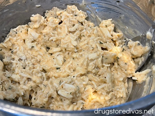 Crab meat in a mayonnaise-based dressing in a silver bowl.