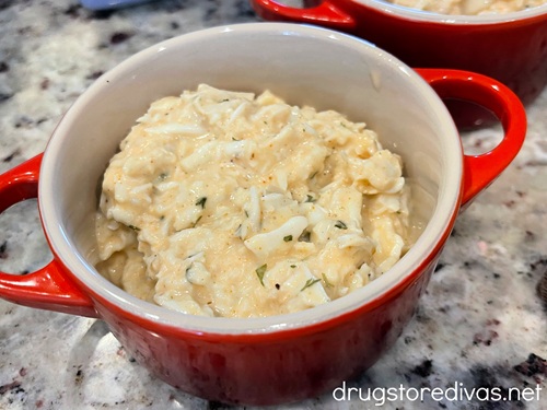 Crab meat in a mayonnaise-based dressing in a red mini Dutch oven.