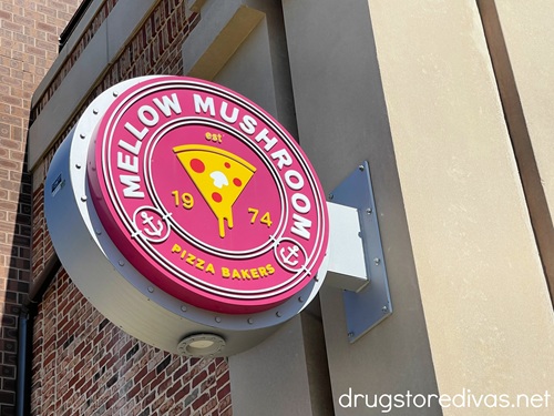 A red, round sign advertising a Mellow Mushroom restaurant.