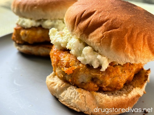 Two cooked Nashville Hot Chicken Burgers on a plate.
