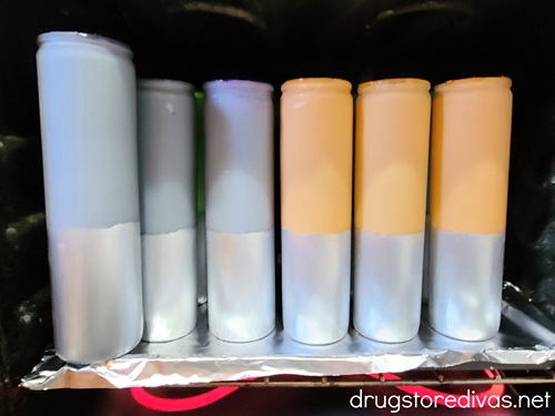 Painted tall candles in an oven.