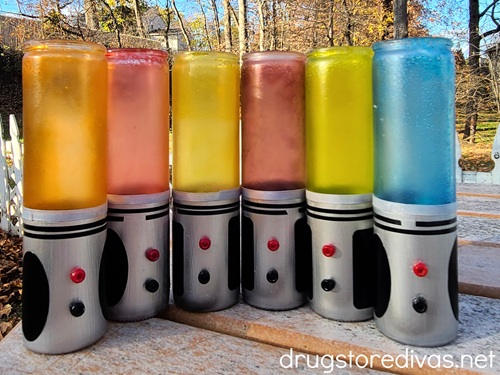 Six DIY Star Wars Lightsabers of various colors outside.