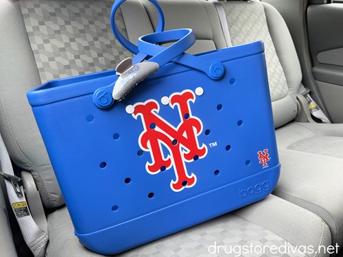 A blue Bogg Bag with a New York Mets logo on it in the backseat of a car.