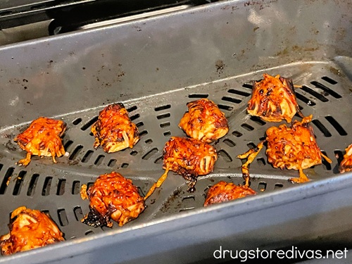Cooked imitation crab bites in an air fryer basket.
