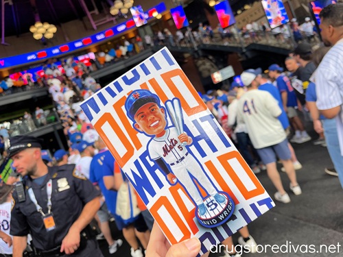 A hand holding a box containing a David Wright bobblehead in Citi Field.