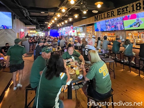 A group of Green Bay Packers fans sitting inside the Draft Kings bar in Nashville.