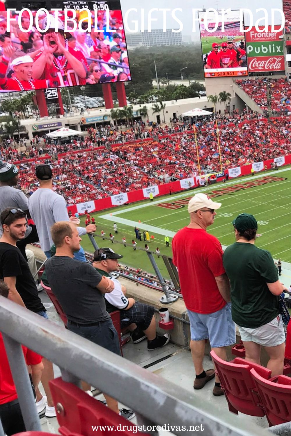 Men in the Tampa Bay Buccaneers football stadium watching a game with the words 