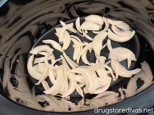 Sliced onions in a slow cooker.