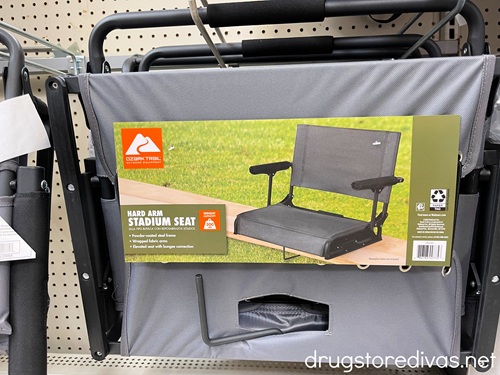 A stadium seat cover in its package on a shelf in a store.