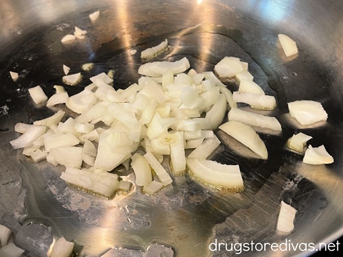 Diced onions in a silver pan.